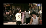 screenshot from Peter Yung's modern day thriller THE SYSTEM (1979); <br>
in the background Chang Cheh's THE DAREDEVILS is announced in the streets of Hong Kong