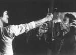 A still of the most famous deleted scene in a martial arts movie ever!<br> (According to Steve Kerridge and Darren Chua in their book "Bruce Lee: Mandarin Superstar", this scene was only shown at the initial screening of the THE BIG BOSS,
on October 17th 1971, which was for cinema owners and prospective buyers only.)