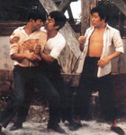 most probably an alternative scene
<br>(This kind of scene – Bruce Lee probably trying to hinder his friends and co-workers from fighting – is not in any known version of THE BIG BOSS.
As it doesn't really fit into the final version as a supplement, it could have been shot by the movie's first director Wu Chia-Hsiang but later being abandoned due to changes in the screenplay by director Lo Wei. The actor on the left doesn't seem to be in the final movie.)