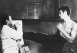 not really a deleted scene, but a still from some kind of rehearsal,
as Bruce Lee does not kick here with his upper body naked in the final version!