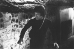 deleted scene <br>(if ever really put on film or just being rehearsed, remains unknown): <br>
Before Bruce Lee finally enters the ventiduct at night,
he takes a longer way <br>through the alleys of the premises of Han's island