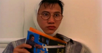 Alex Man is reading a magazine with 