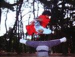 Hwang Jeong-ri performing a flying side kick through the legs of Kim Doo-han.